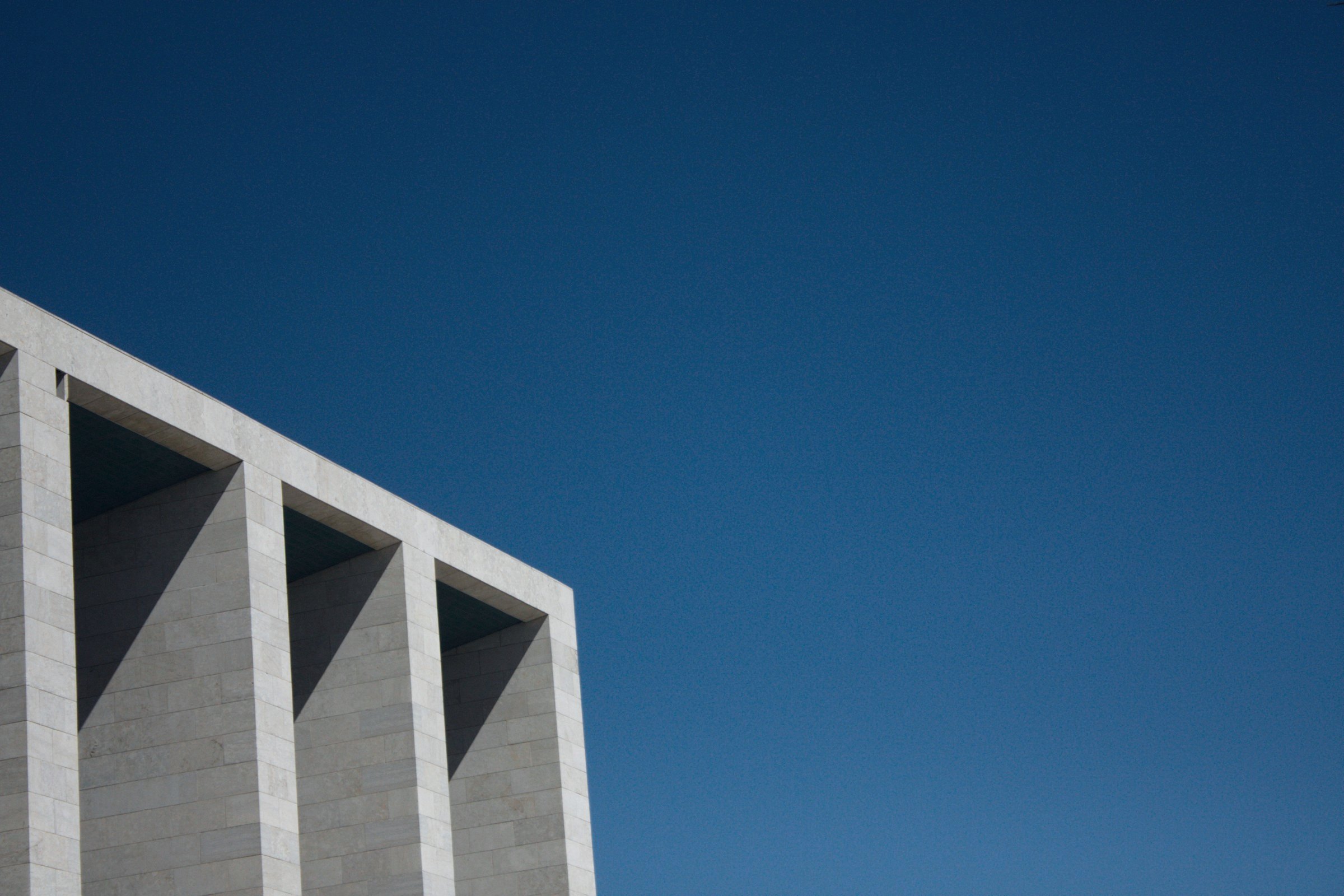 Concrete building edge against a deep blue sky